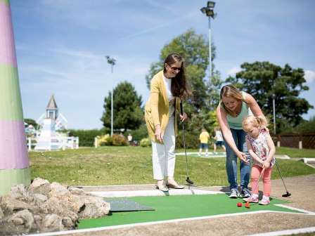 Family playing minigolf at Caister on Sea Holiday Park