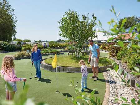 Family playing crazy golf at Hopton Holiday Village