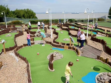 Families playing crazy golf at Haven Kent Coast Holiday Park (previously Allhallows)