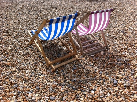 Deckchairs on a shingly beach