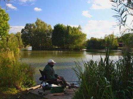 Fishing lake with angler at Tattershall Lakes in Lincolnshire