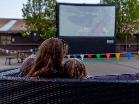 Family watching outdoor cinema at Tattershall Lakes